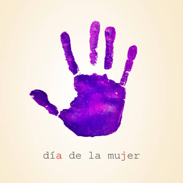 a violet handprint and the text dia de la mujer, womens day in spanish, on a beige background