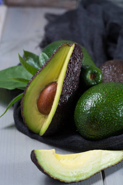 istock Green ripe avocado with leaves 646452742