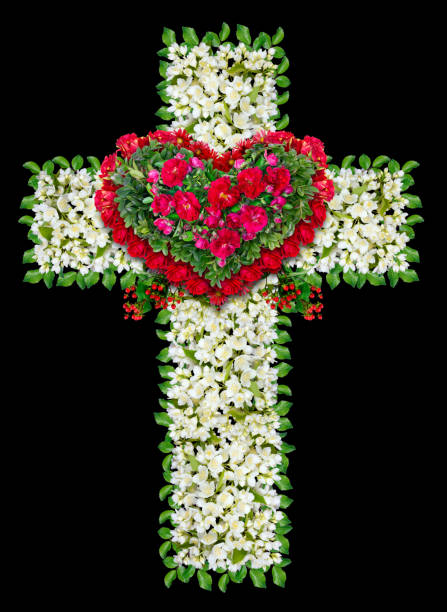 istock Mourning Jesus wreath as cross . Isolated on black handmade abstract collage from white and red flowers and green leaves 646453870