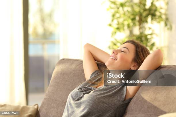 Girl Relaxing On A Sofa At Home Stock Photo - Download Image Now - Domestic Life, Relaxation, Home Interior