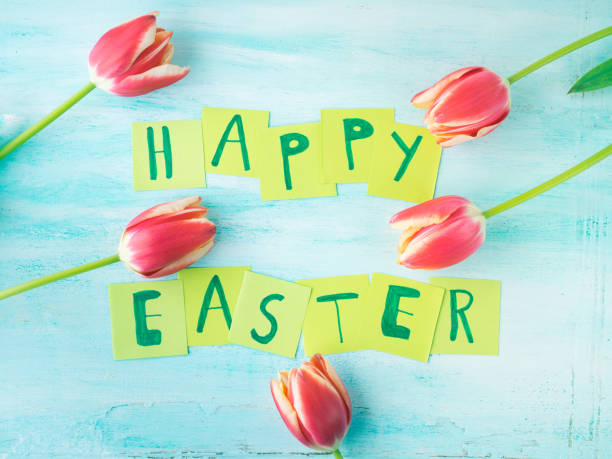 istock Happy Easter background tulips flowers hand written letters 646460246