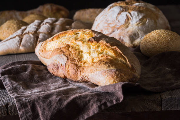 istock Several types of fresh bread lying on an old wooden table 646474334