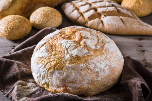 istock Several types of fresh bread lying on an old wooden table 646474704