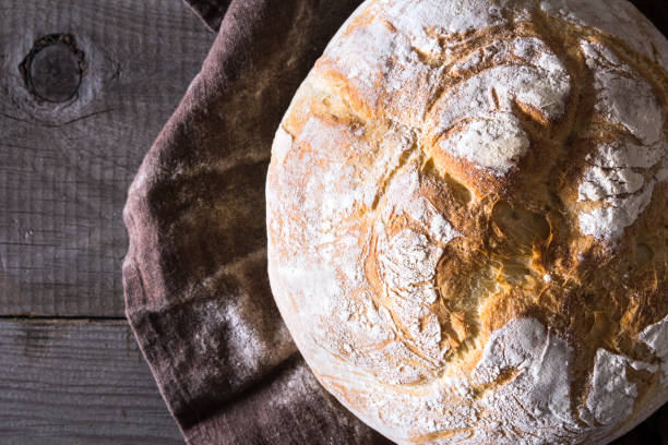 istock Freshly baked traditional bread on wooden table 646476392
