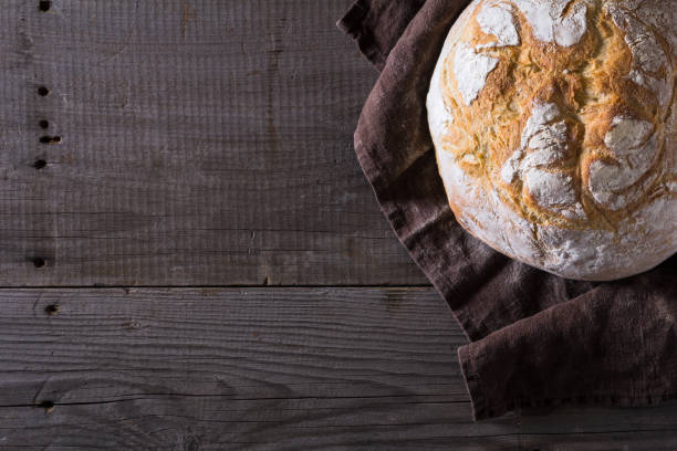 istock Freshly baked traditional bread on wooden table 646484234