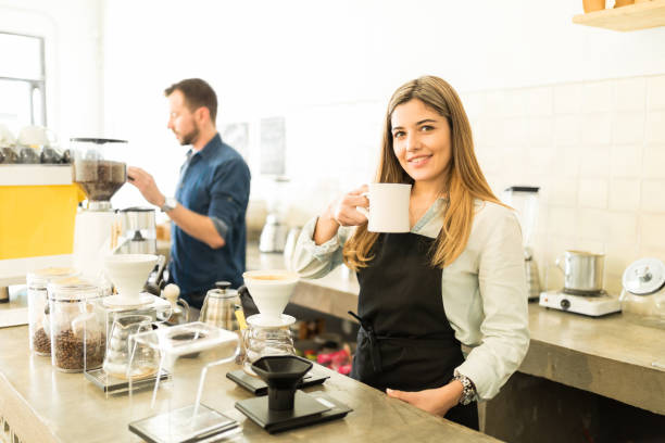 istock Female barista drinking a cup of coffee 646485276