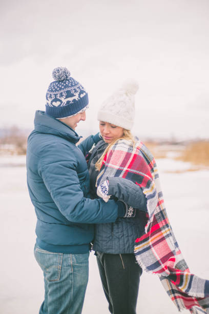 istock Couples holding each other on the shore of lake 646485870