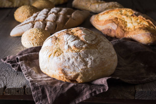 istock Several types of fresh bread lying on an old wooden table 646485886