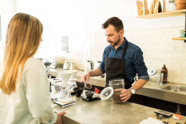 istock Barista weighing coffee grains in a cafe 646487364