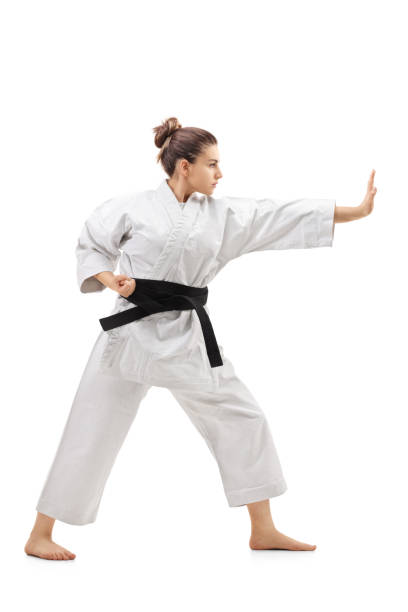 istock Young woman in a kimono practicing karate 646490338