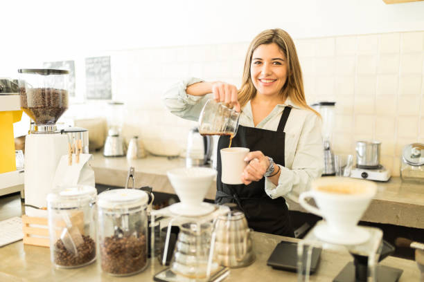 istock Cute female barista serving some coffee 646490738