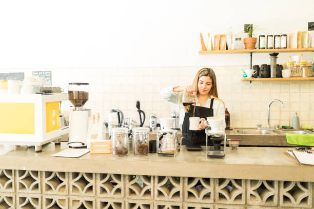 istock Cute barista working in a coffee shop 646493724