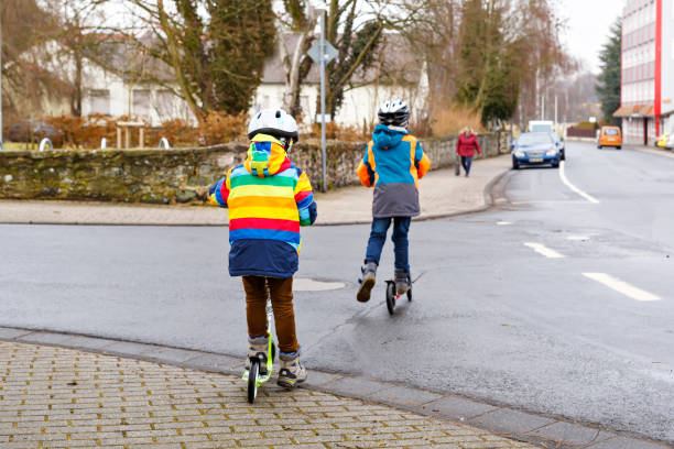 istock Two little kid boys, best friends riding on scooter 646493854