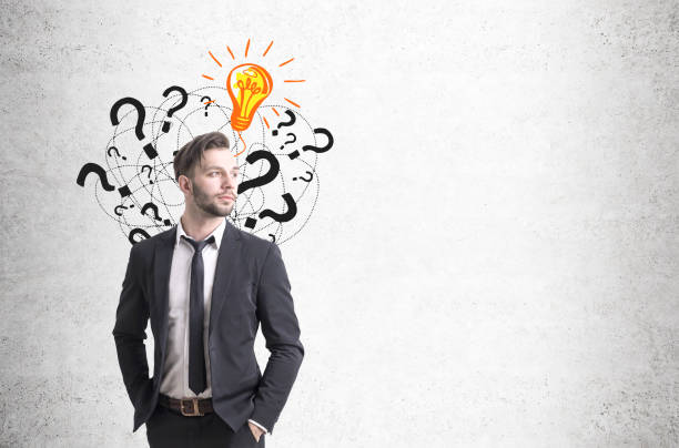 istock Confident businessman and questions, light bulb 646494346