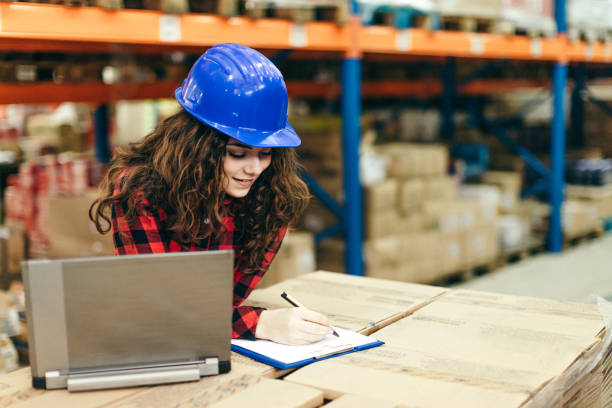 istock Businesswoman at warehouse checking inventory 646494734