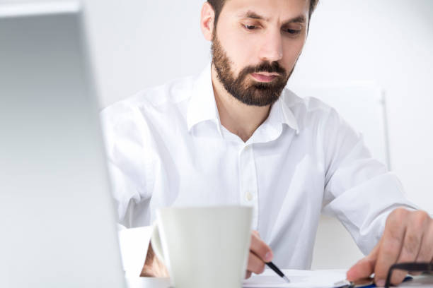 istock Close up of man signing papers 646499776