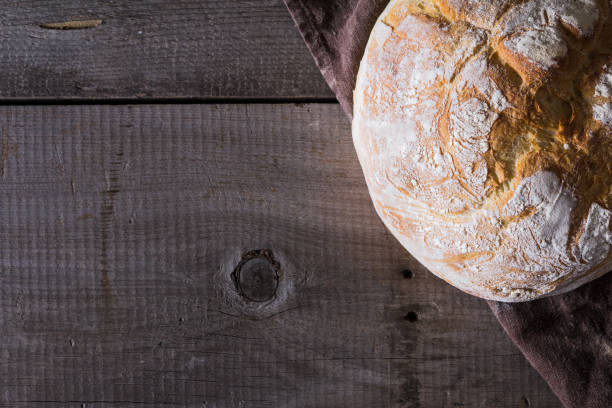 istock Freshly baked traditional bread on wooden table 646504376