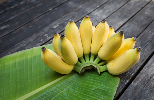 Cultivated banana on wooden floor, outdoor day light