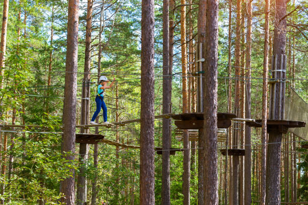 istock Girl on hinged trail in extreme rope Park 646512204