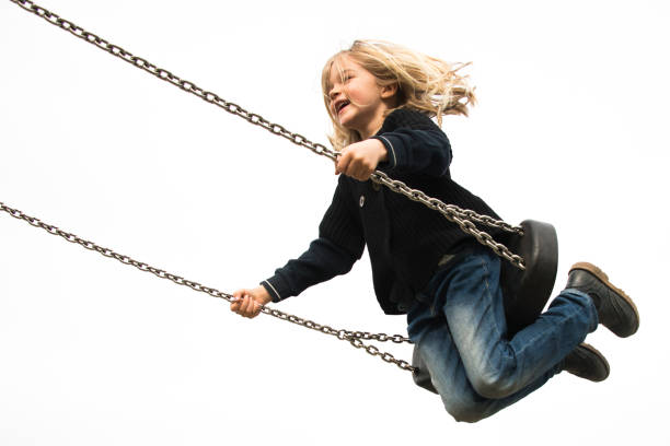 istock Little child blond girl having fun on a swing 646514842