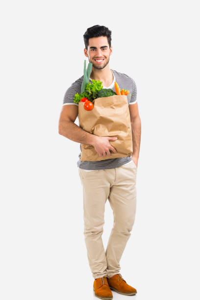 istock Man carrying a bag full of vegetables 646515474