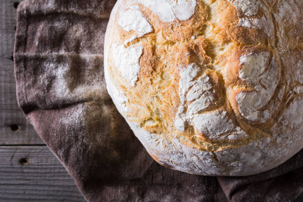 istock Freshly baked traditional bread on wooden table 646515964