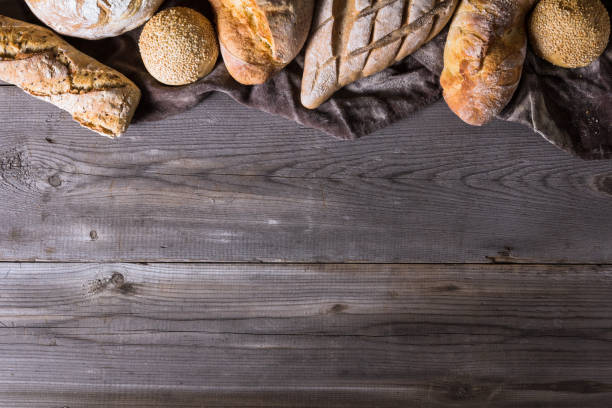 istock Several types of fresh bread lying on an old wooden table 646516766