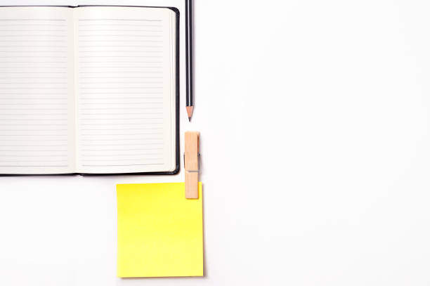 istock yellow notepad with notebook and a pencil isolated on white background 646517180