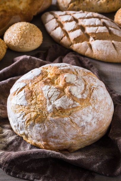 istock Several types of fresh bread lying on an old wooden table 646517384