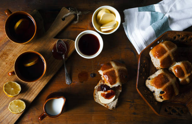 istock Easter breakfast with traditional hot Cross Bun and jam. From above on wooden table. 646517730