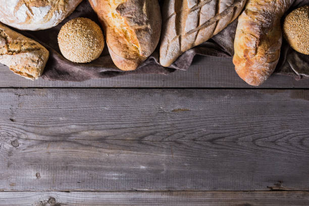 istock Several types of fresh bread lying on an old wooden table 646517978