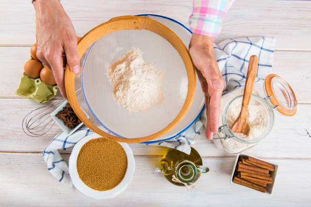 istock Cook woman sieving flour with her hands 646518572