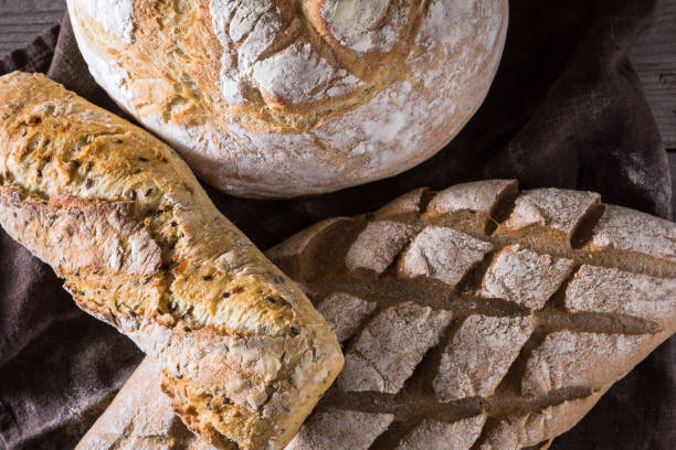 istock Several types of fresh bread lying on an old wooden table 646519166
