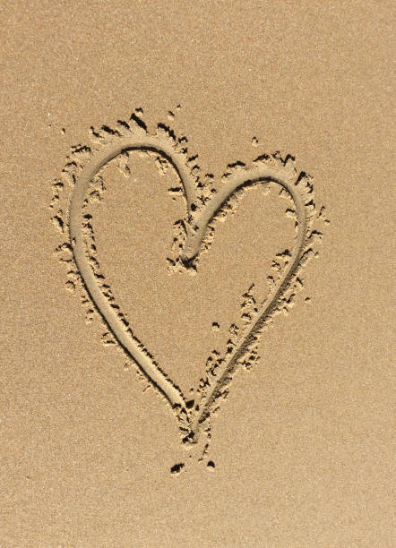 istock Love heart in the sand 646520704