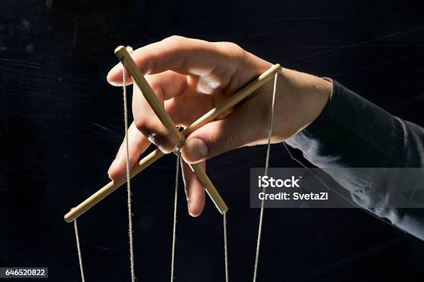 Manipulation Concept On Black Stock Photo - Download Image Now - Puppet, Marionette, Domination