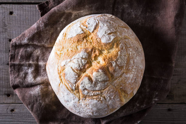 istock Freshly baked traditional bread on wooden table 646524744