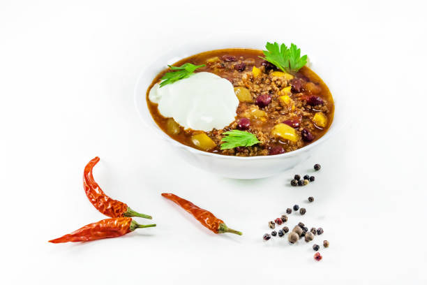 mexican chilly with meat and black beans in a white bowl