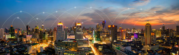 istock Panorama bangkok at night city and office building with wifi network connection network. business concept 646533196