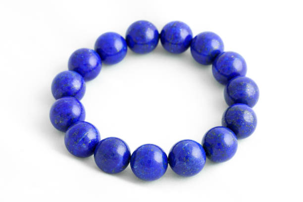 istock Beautiful high grade royal blue Lapis lazuli beads in bracelet on white background 646536152