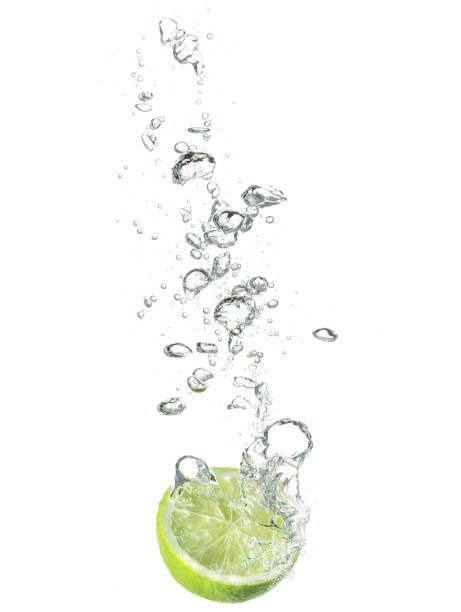 istock lime dropped in water isolated on white 646540974