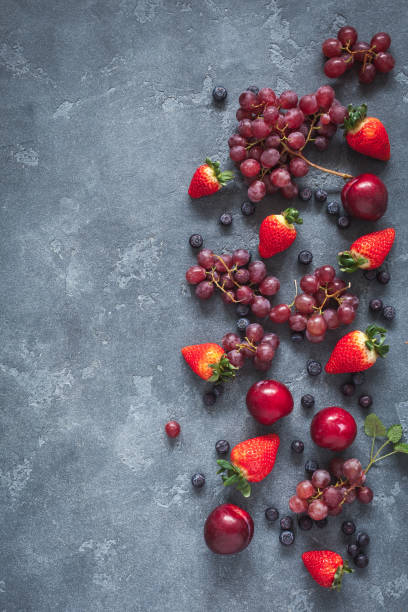 istock Strawberries, blueberries, plums, grapes. Flat lay, top view 646558238