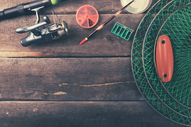 istock fishing equipment on old wooden table with copy space 646563296