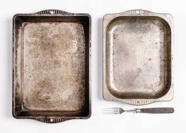 istock Blank space in two antique metal baking trays on white background 646570026