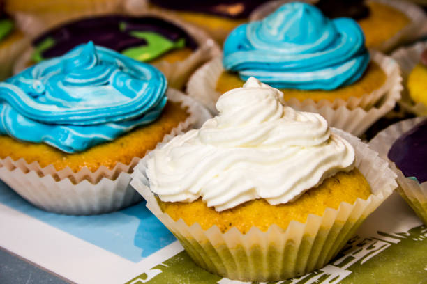 Some colored cupcakes with cream stock photo