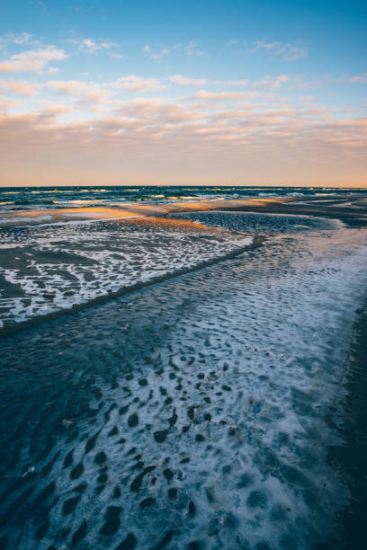 istock Lump of ice on the beach 646586128