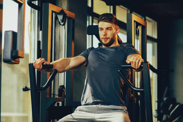 istock Handsome man in the gym doing chest exercise 646590950