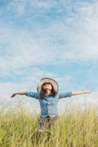 istock Young girl sitting alone on a grass outdoors. Loneliness 646597634