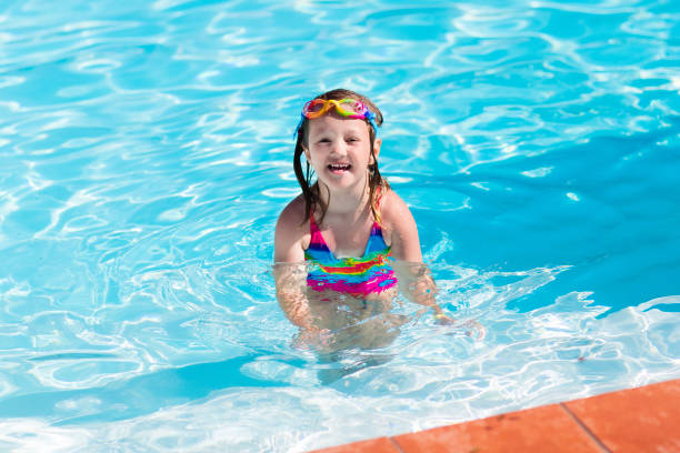 istock Child learning to swim in pool 646597972