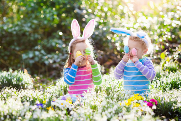 istock Kids on Easter egg hunt in blooming spring garden 646602332