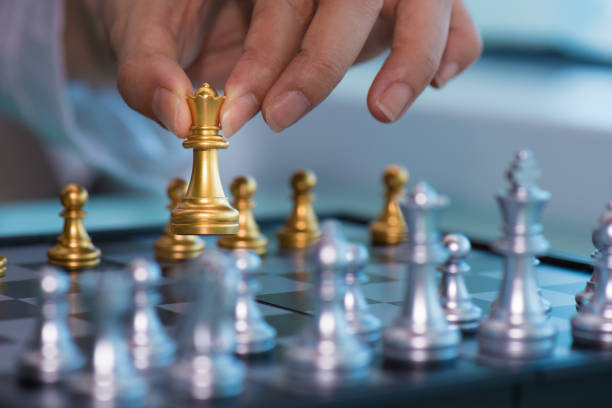 istock Woman's hand pick up  chess pieces 646608262